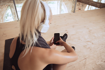 Image showing A young athletic woman working out on an abandoned construction site