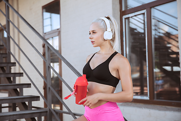 Image showing A young athletic woman working out on a stairs outdoors