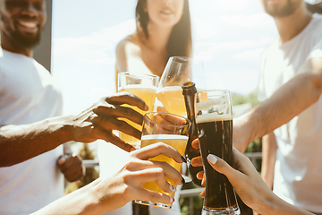 Image showing Young group of friends drinking beer and celebrating together