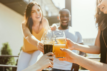 Image showing Young group of friends drinking beer and celebrating together