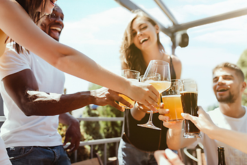 Image showing Young group of friends drinking beer and celebrating together