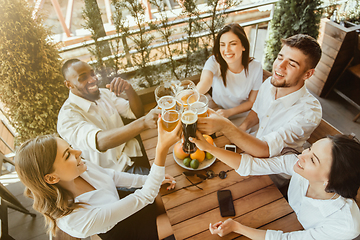 Image showing Young group of friends drinking beer and celebrating together