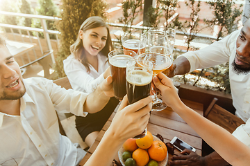 Image showing Young group of friends drinking beer and celebrating together