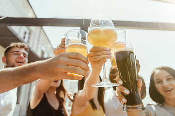 Image showing Young group of friends drinking beer and celebrating together