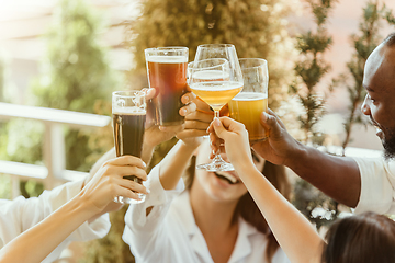 Image showing Young group of friends drinking beer and celebrating together