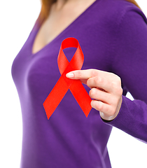 Image showing Woman is holding the red awareness ribbon