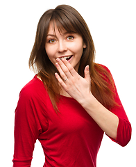 Image showing Woman is covering her mouth in astonishment