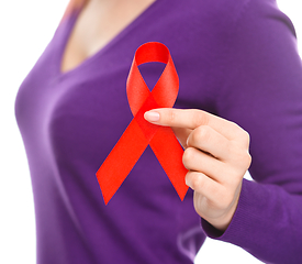 Image showing Woman is holding the red awareness ribbon