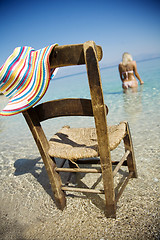 Image showing blond female slowly entering the water at the beach