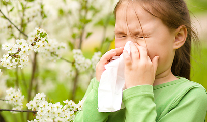 Image showing Little girl is blowing her nose