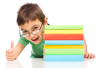 Image showing Little boy is reading a book