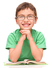 Image showing Little boy is reading a book