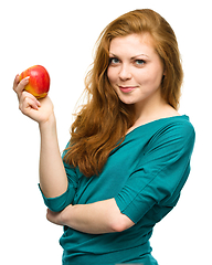 Image showing Young happy girl with apple