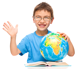 Image showing Little boy is holding globe