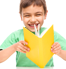 Image showing Little boy is reading a book