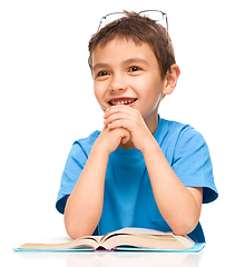 Image showing Little boy is reading a book