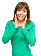 Image showing Woman is holding her face in astonishment