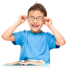 Image showing Little boy is reading a book