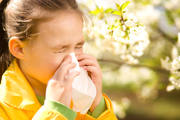 Image showing Little girl is blowing her nose