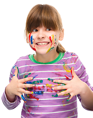 Image showing Portrait of a cute girl playing with paints