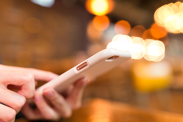 Image showing Woman use on mobile phone with bokeh background