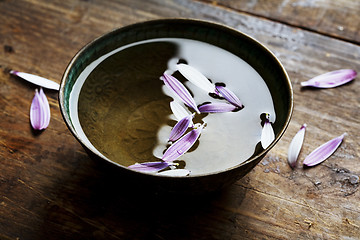 Image showing rustic bowl with petals