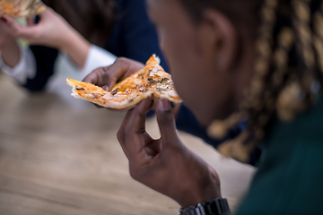 Image showing multiethnic business team eating pizza