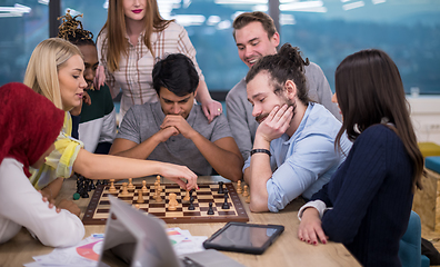 Image showing multiethnic group of business people playing chess