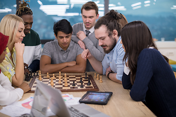 Image showing multiethnic group of business people playing chess