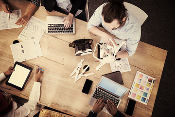 Image showing top view of multiethnic business team learning about drone techn