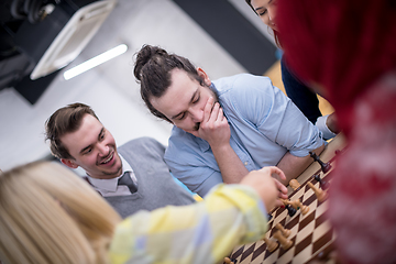 Image showing multiethnic group of business people playing chess