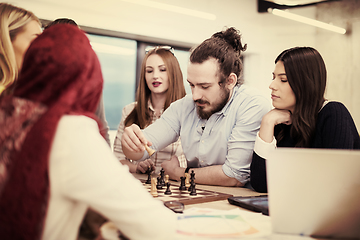 Image showing multiethnic group of business people playing chess