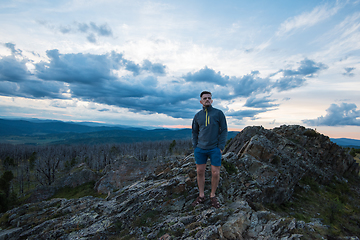 Image showing Man standing on top of cliff