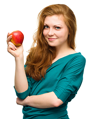 Image showing Young happy girl with apple