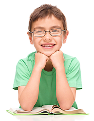 Image showing Little boy is reading a book