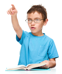 Image showing Little boy is reading a book