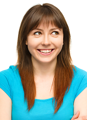 Image showing Young happy woman is looking up and smile