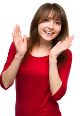 Image showing Woman is holding her face in astonishment