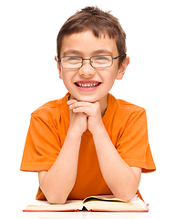 Image showing Little boy is reading a book