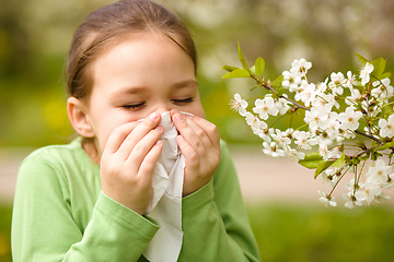 Image showing Little girl is blowing her nose