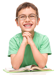 Image showing Little boy is reading a book