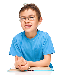 Image showing Little boy is reading a book