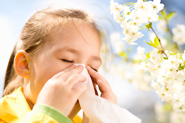 Image showing Little girl is blowing her nose