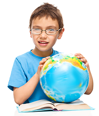 Image showing Little boy is holding globe