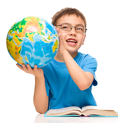 Image showing Little boy is holding globe