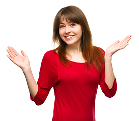 Image showing Portrait of a young woman raised her hands up