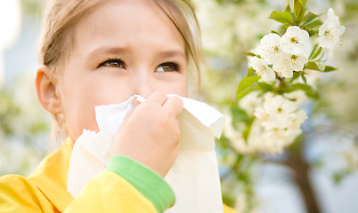 Image showing Little girl is blowing her nose