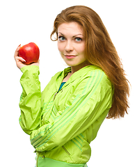 Image showing Young happy girl with apple