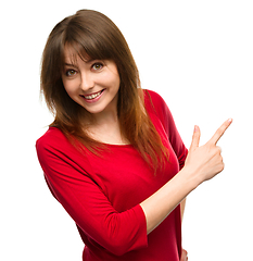 Image showing Portrait of a young woman pointing to the right