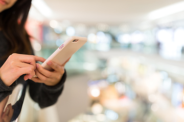 Image showing Woman working on mobile phone in shopping mall